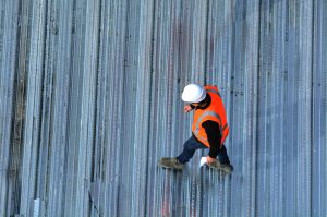 Worker Inspecting Roof