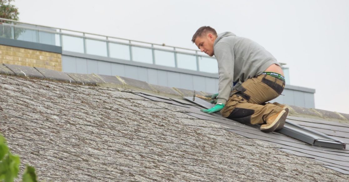Construction worker installing roof shingles — Florida 25 percent roof replacement rule