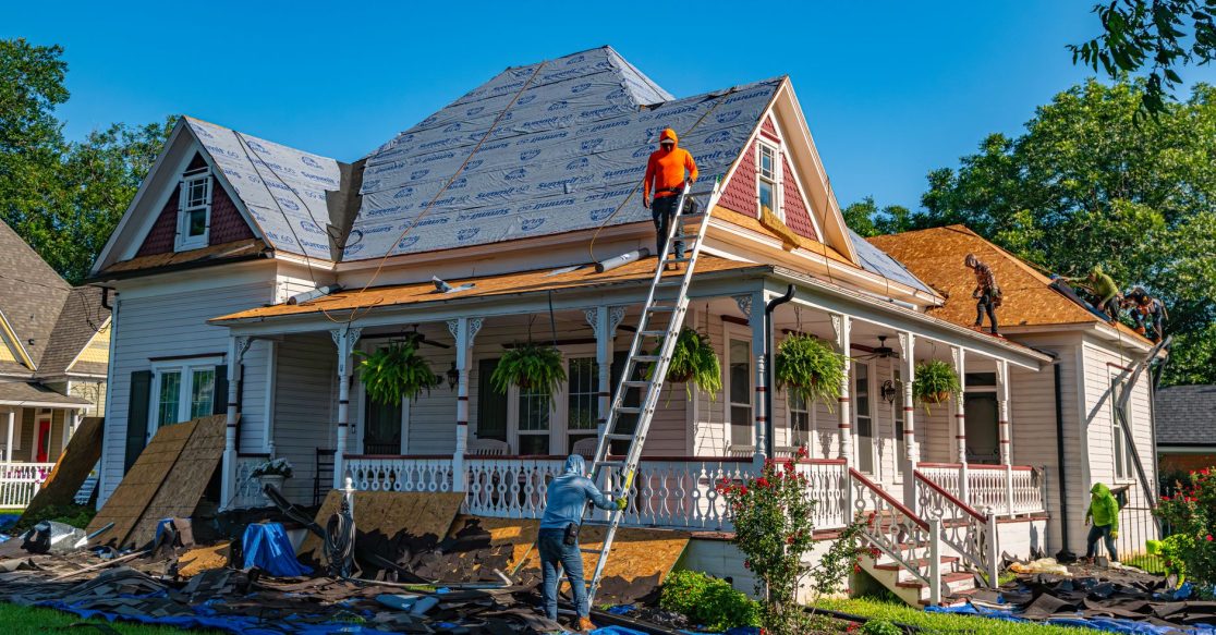 Roofers replacing shingles on a residential home in Florida