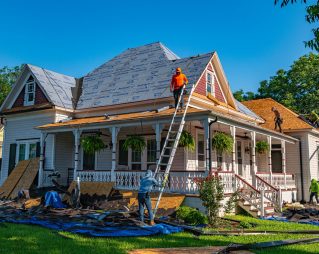 Roofers replacing shingles on a residential home in Florida